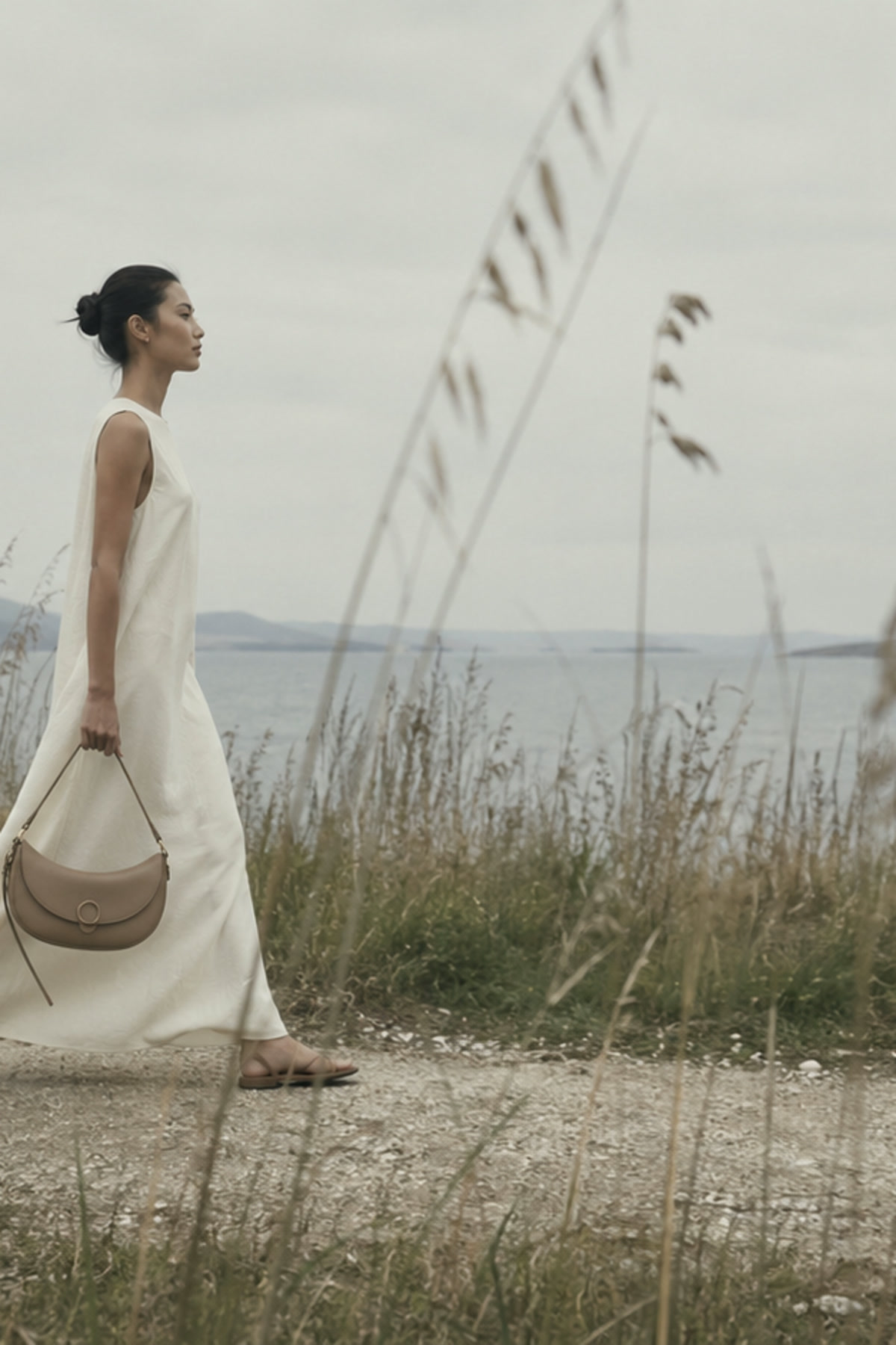 AELA campaign model carrying a handbag